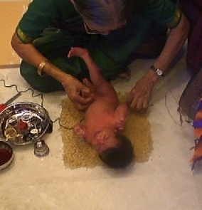 Ammamma tying the Arana Kayaru with me lying on the Nellu.